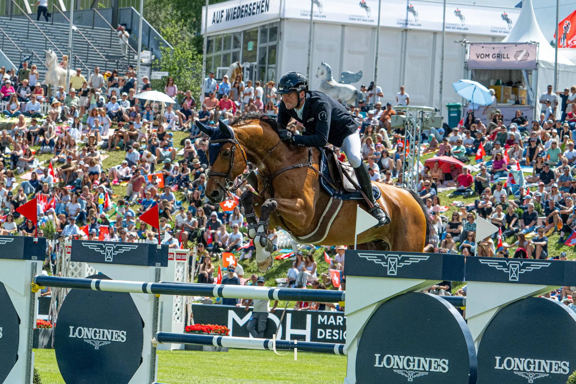 Bryan Balsiger clearing a Longines oxer in front of a full crowd